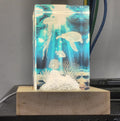 Undersea scene engraved inside a glowing crystal block